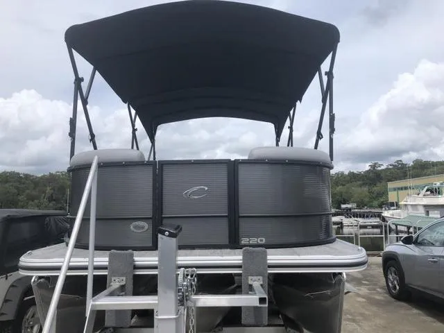 Slide: The Image of 2025 Crest Classic LX 220 SLRC boat deck with stainless steel ladder and covered engine. - 24