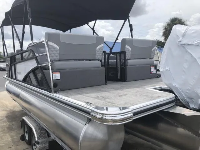 Slide: The Image of 2025 Crest Classic LX 220 SLRC boat display with Nauti Table, additional charge sign. - 25