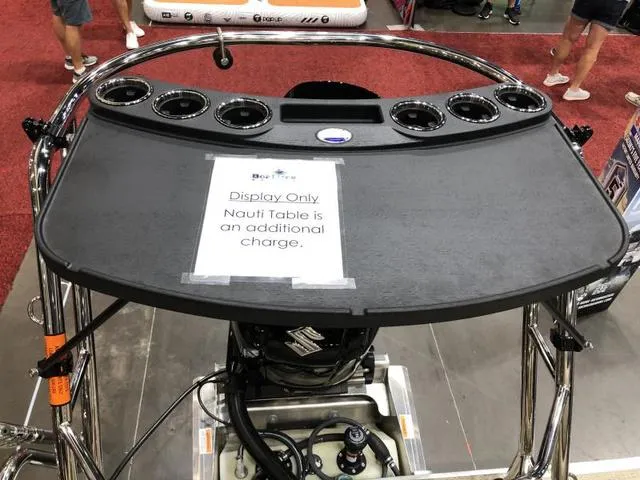 Slide: The Image of 2025 Crest Classic LX 220 SLRC boat interior with gray captain's chair and cup holders. - 27