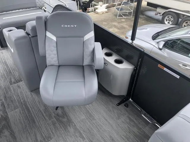 Slide: The Image of 2025 Crest Classic LX 220 SLRC pontoon boat with luxurious gray seating and modern design. - 29