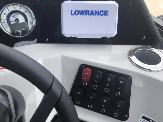 Slide: The Image of 2025 Crest Classic LX 220 SLRC boat interior with gray seating and modern dashboard. - 34