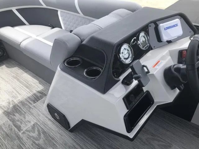 Slide: The Image of 2025 Crest Classic LX 220 SLRC boat interior with gray seating and steering console. - 4