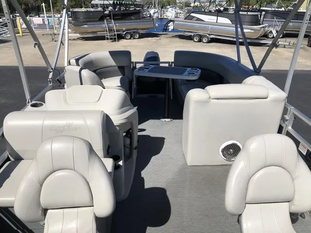 Slide: The Image of 2022 SunChaser Vista 188 Sport Fish pontoon boat interior with seating and table. - 11