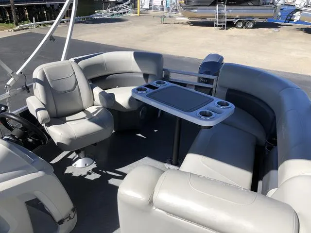 Slide: The Image of 2022 SunChaser Vista 188 Sport Fish boat interior with seating and table, ideal for fishing trips. - 13