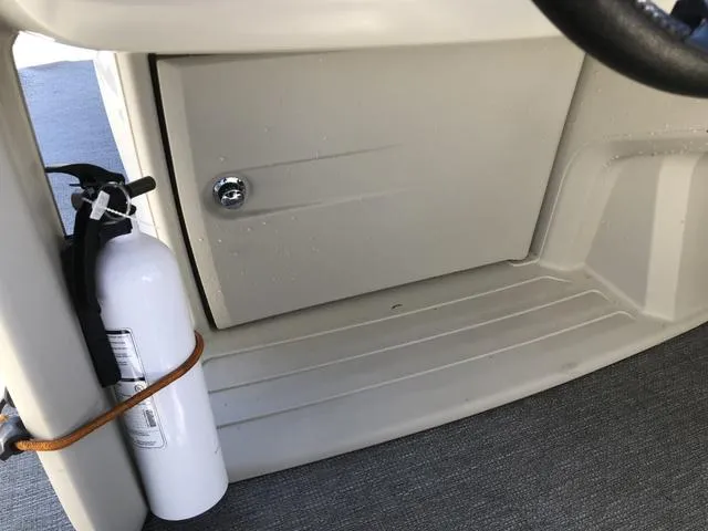 Slide: The Image of 2022 SunChaser Vista 188 Sport Fish boat interior with fire extinguisher and storage compartment. - 20