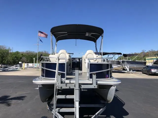 Slide: The Image of 2022 SunChaser Vista 188 Sport Fish pontoon boat with canopy, parked on a sunny day. - 4