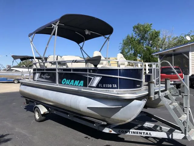 Slide: The Image of 2022 SunChaser Vista 188 Sport Fish pontoon boat on trailer, with canopy and "Ohana" lettering. - 5