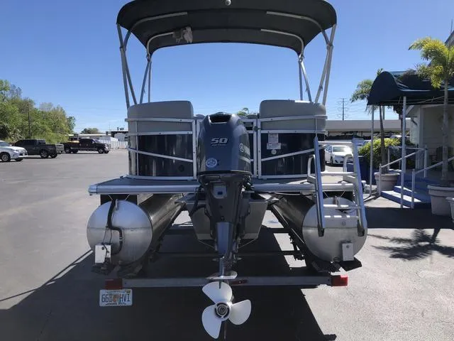 Slide: The Image of 2022 SunChaser Vista 188 Sport Fish pontoon boat with outboard motor, parked outdoors. - 7