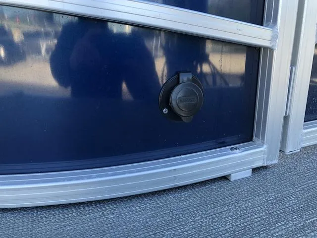 Slide: The Image of 2022 SunChaser Vista 188 Sport Fish boat exterior detail with a black circular fixture. - 8