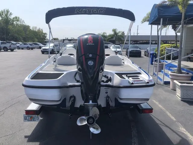 Slide: The Image of 2021 Nitro Z19 Sport boat with outboard motor in a parking lot. - 10