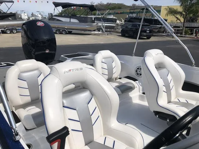 Slide: The Image of 2021 Nitro Z19 Sport boat interior with white and blue seating. - 12