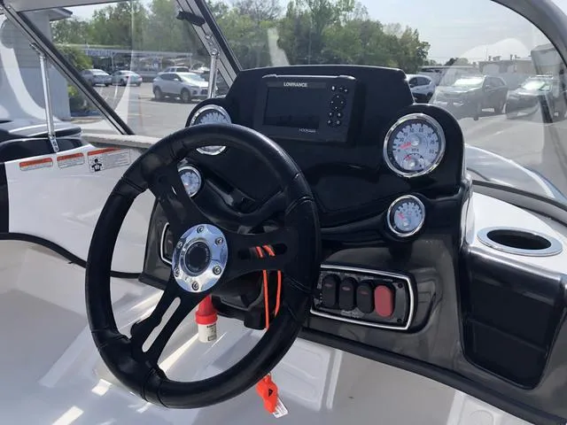 Slide: The Image of 2021 Nitro Z19 Sport boat dashboard with steering wheel and gauges. - 13