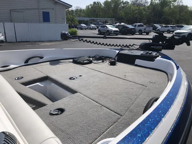 Slide: The Image of 2021 Nitro Z19 Sport boat deck with Minn Kota trolling motor in parking lot. - 14
