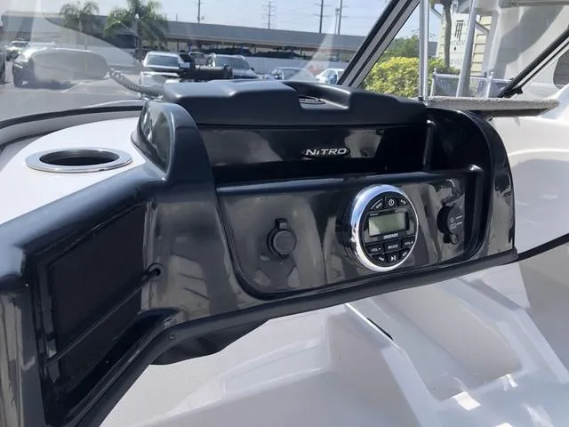 Slide: The Image of Dashboard of a 2021 Nitro Z19 Sport boat with control panel and cup holder. - 18