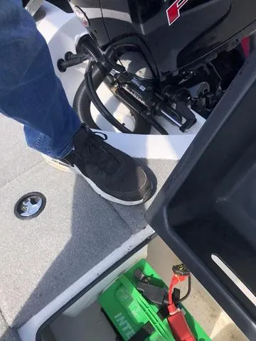 Slide: The Image of Person standing on a 2021 Nitro Z19 Sport boat near the engine and battery compartment. - 20