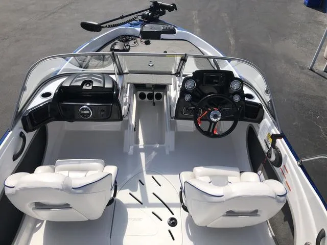 Slide: The Image of 2021 Nitro Z19 Sport boat interior with steering wheel and seating. - 21