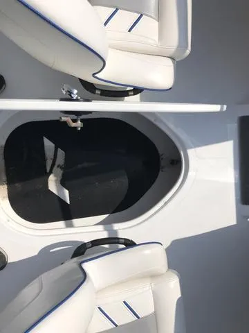 Slide: The Image of 2021 Nitro Z19 Sport boat interior with white seating and storage compartment. - 24