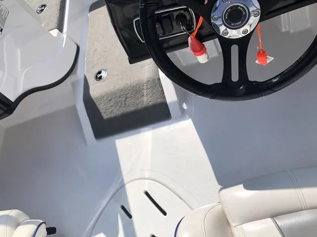 Slide: The Image of Interior view of a 2021 Nitro Z19 Sport boat, featuring steering wheel and seating. - 25