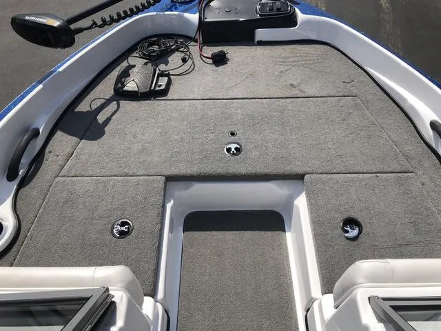 Slide: The Image of 2021 Nitro Z19 Sport boat deck with gray carpet and fishing equipment. - 26