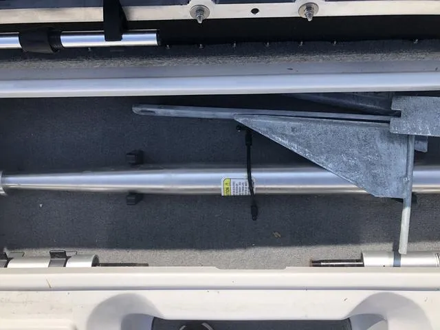 Slide: The Image of 2021 Nitro Z19 Sport boat compartment with metal rod and anchor storage. - 28