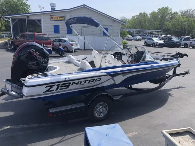 Slide: The Image of 2021 Nitro Z19 Sport boat on trailer in parking lot. - 6