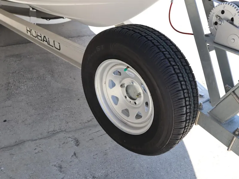Slide: The Image of Trailer wheel of 2023 Robalo 226 Cayman boat on concrete surface. - 12