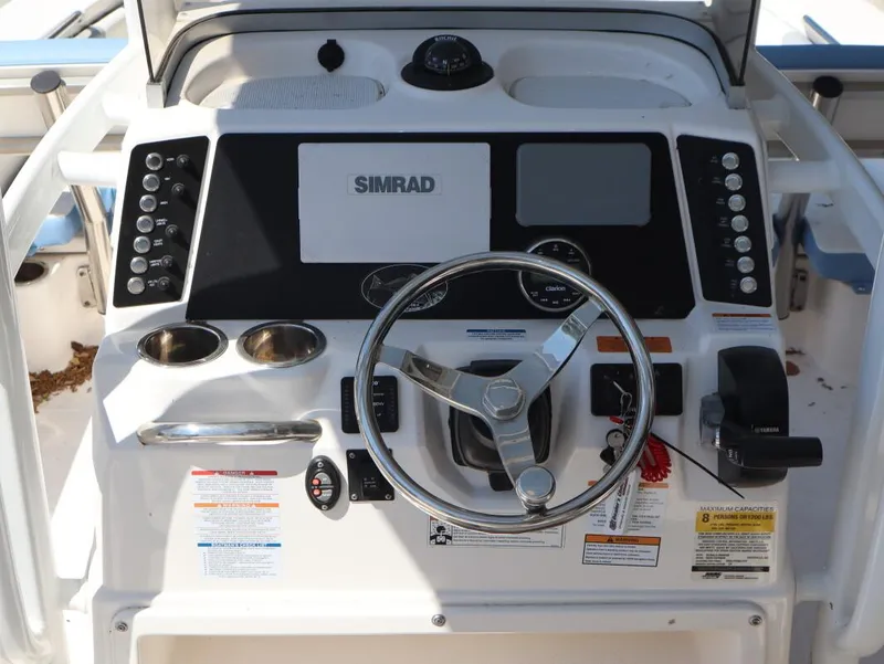 Slide: The Image of Control panel of 2023 Robalo 226 Cayman boat with steering wheel and Simrad display. - 15