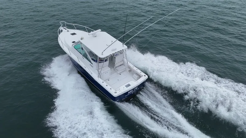 Slide: The Image of 2011 Rampage 34 IPS boat cruising on open water, creating a wake. - 2