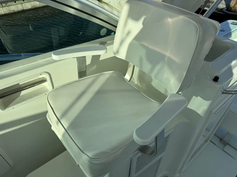Slide: The Image of White captain's chair on 2011 Rampage 34 IPS boat, sunlight casting shadows. - 33