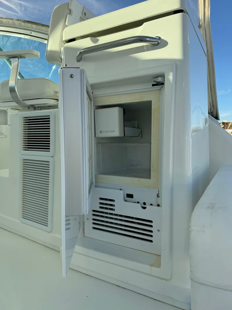 Slide: The Image of 2011 Rampage 34 IPS boat with open mini fridge on deck. - 34