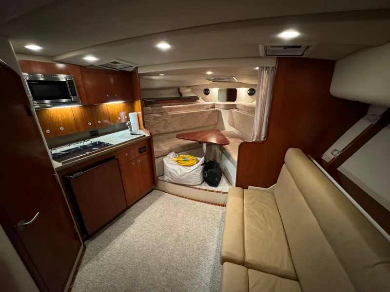 Slide: The Image of Interior of 2011 Rampage 34 IPS boat with kitchen and seating area. - 36