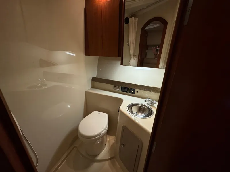 Slide: The Image of Compact bathroom in 2011 Rampage 34 IPS boat with toilet, sink, and mirror. - 39