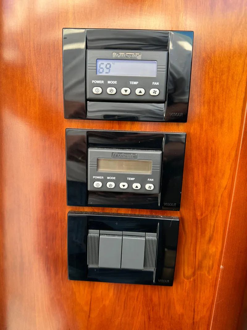 Slide: The Image of Control panel on a 2011 Rampage 34 IPS boat with digital displays and buttons. - 42