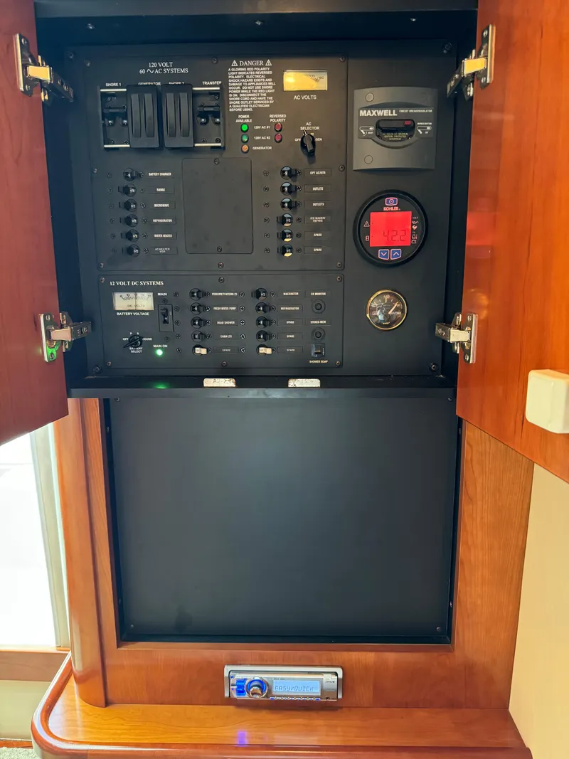 Slide: The Image of Electrical control panel inside a 2011 Rampage 34 IPS boat, featuring switches and gauges. - 43