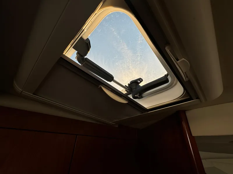 Slide: The Image of Open hatch on 2011 Rampage 34 IPS boat, showing clear sky view. - 47