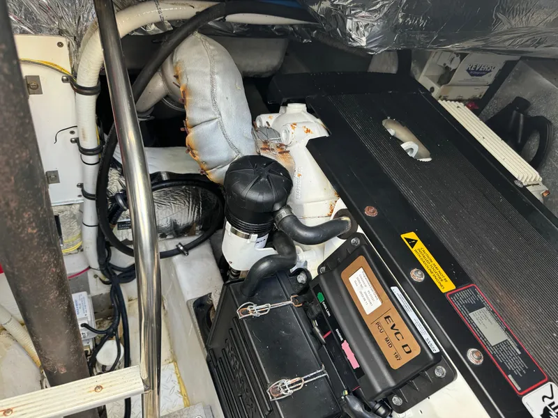 Slide: The Image of Engine room of 2011 Rampage 34 IPS boat, showcasing mechanical components and wiring. - 49