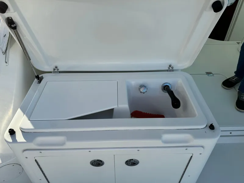 Slide: The Image of Open sink and storage area on 2011 Rampage 34 IPS boat. - 59