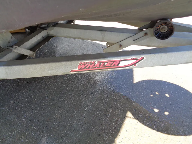 Slide: The Image of Trailer for 2001 Boston Whaler 13 Sport boat, featuring logo and metal frame. - 10