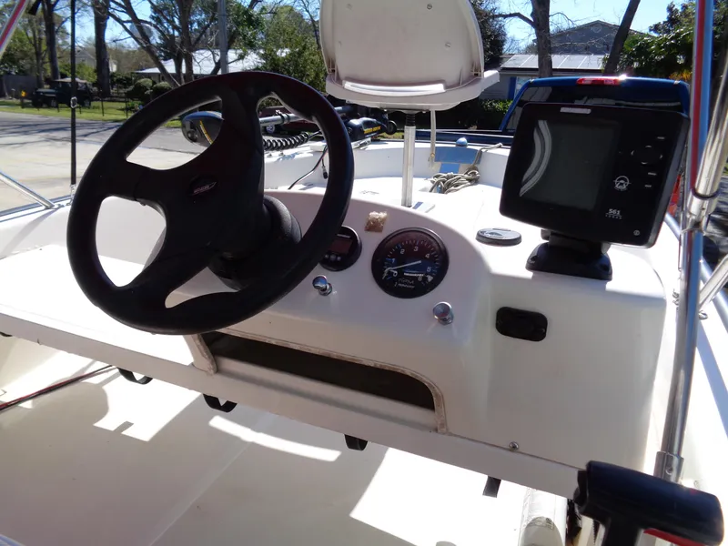 Slide: The Image of 2001 Boston Whaler 13 Sport boat dashboard with steering wheel and navigation equipment. - 6