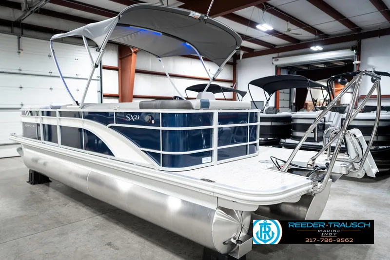 Slide: The Image of 2025 Bennington 23 S Cruise pontoon boat in showroom with canopy and sleek design. - 10