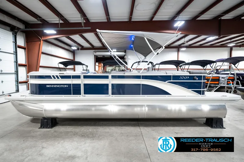 Slide: The Image of 2025 Bennington 23 S Cruise pontoon boat in a showroom setting. - 11