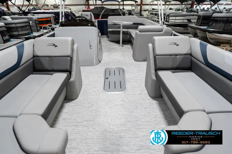 Slide: The Image of 2025 Bennington 23 S Cruise pontoon boat interior with gray seating and spacious layout. - 16
