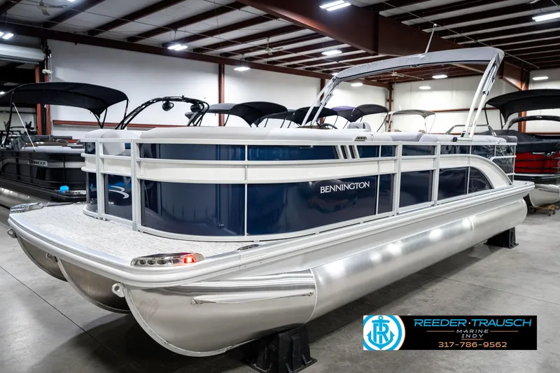 Slide: The Image of 2025 Bennington 23 S Cruise pontoon boat in showroom, side view. - 2