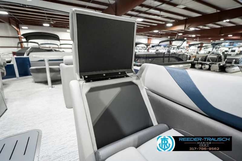 Slide: The Image of 2025 Bennington 23 S Cruise boat interior with open storage compartment in showroom. - 24
