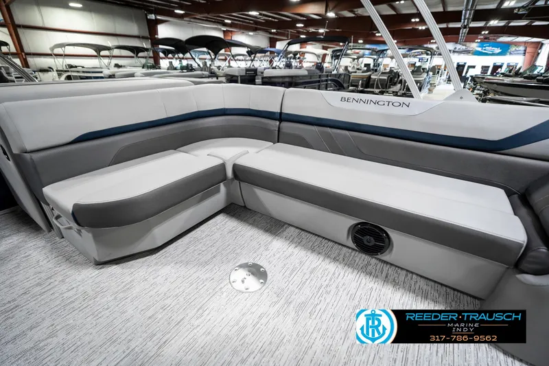 Slide: The Image of 2025 Bennington 23 S Cruise boat interior with gray seating in a showroom. - 26