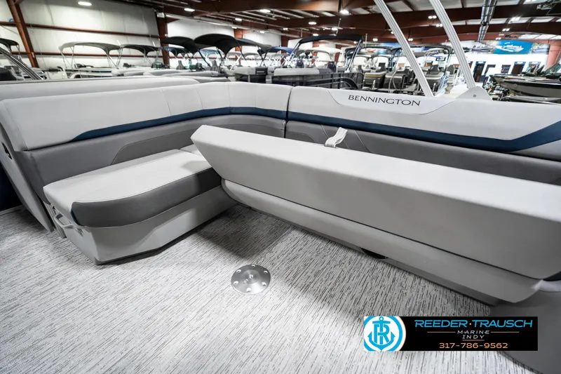 Slide: The Image of 2025 Bennington 23 S Cruise boat interior with gray seating in showroom. - 27