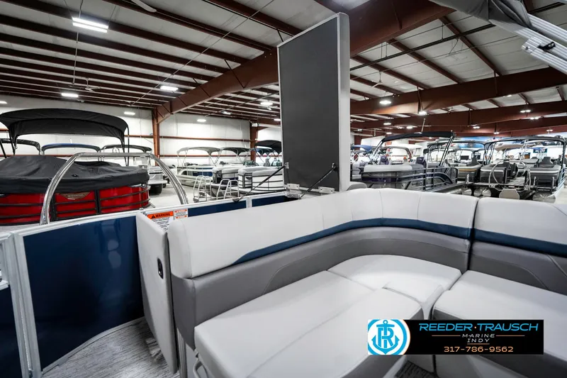 Slide: The Image of 2025 Bennington 23 S CRUISE pontoon boat interior in showroom, featuring sleek seating design. - 31