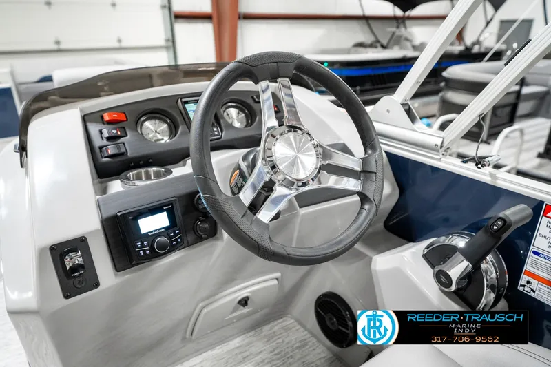 Slide: The Image of 2025 Bennington 23 S Cruise boat dashboard with steering wheel and control panel. - 33