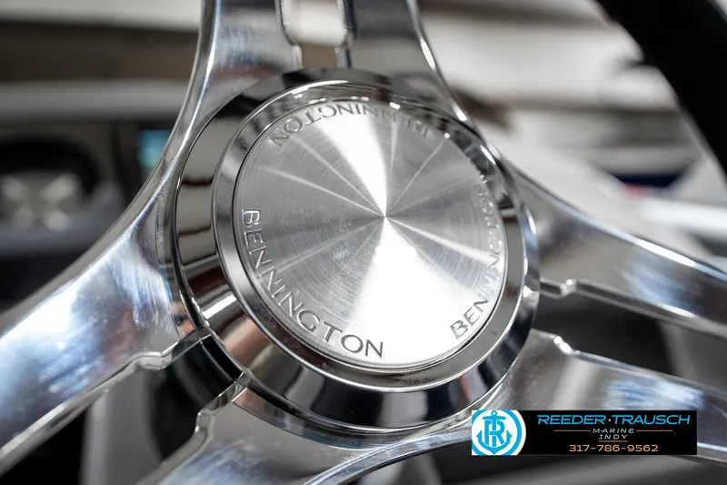Slide: The Image of 2025 Bennington 23 S CRUISE steering wheel close-up with Reeder-Trausch logo. - 34