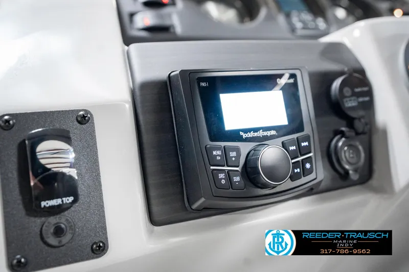 Slide: The Image of Control panel of 2025 Bennington 23 S Cruise boat with audio system and power top switch. - 35